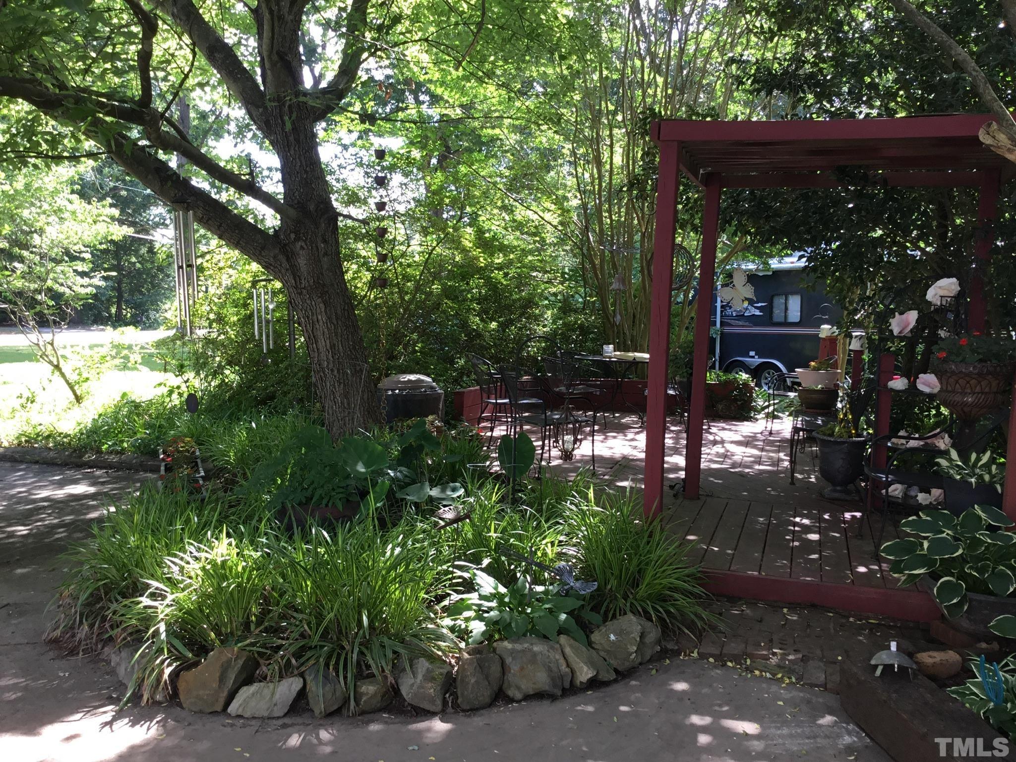 155 Hesters Store Road Roxboro, NC 27574 - Photo 62 of 77 a backyard of a house with lots of green space and fountain