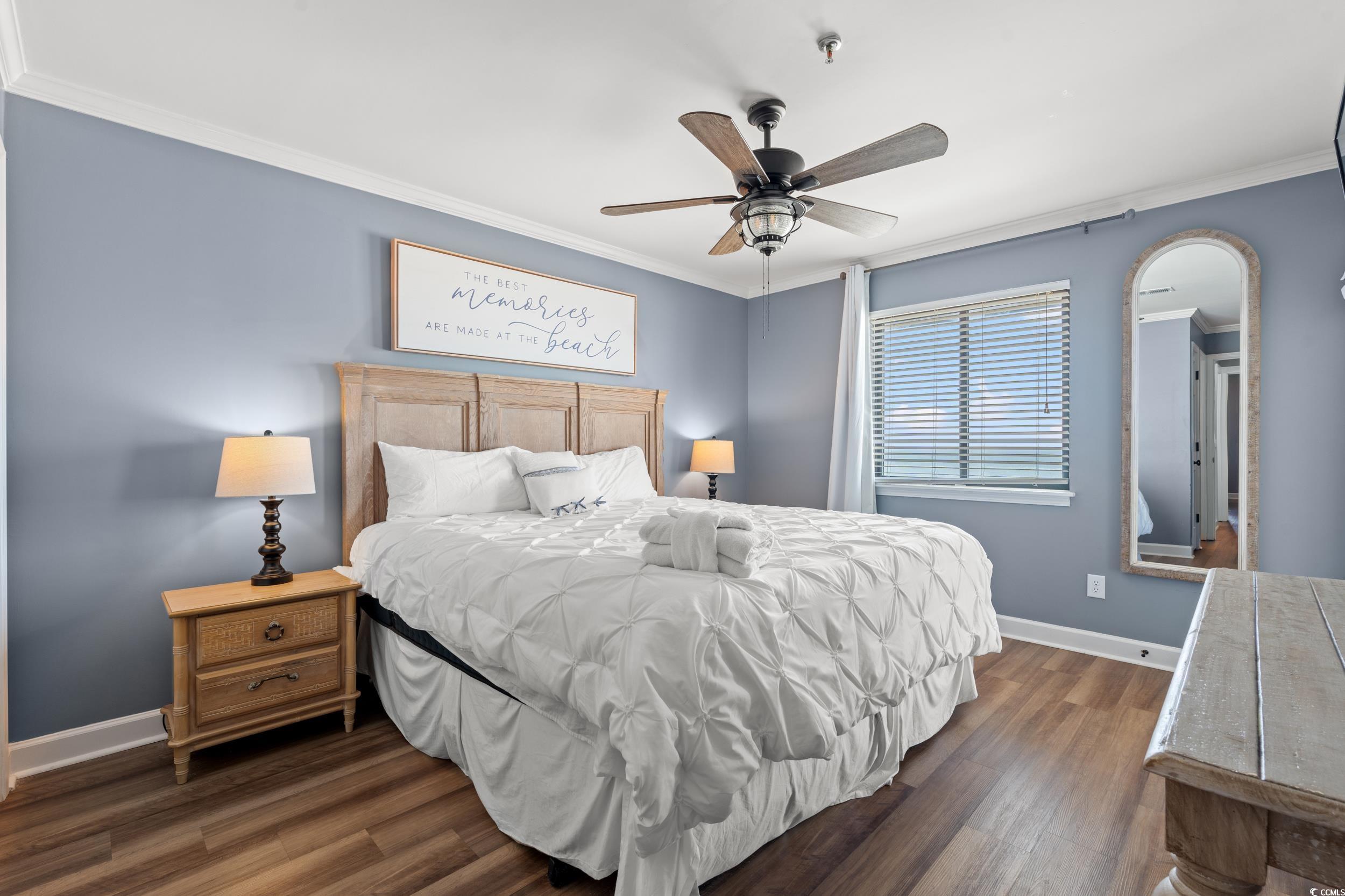 917 Ocean Boulevard South, Unit 304 Surfside Beach, SC 29575 - Photo 15 of 38 Bedroom featuring crown molding, dark wood-style flooring, and ceiling fan