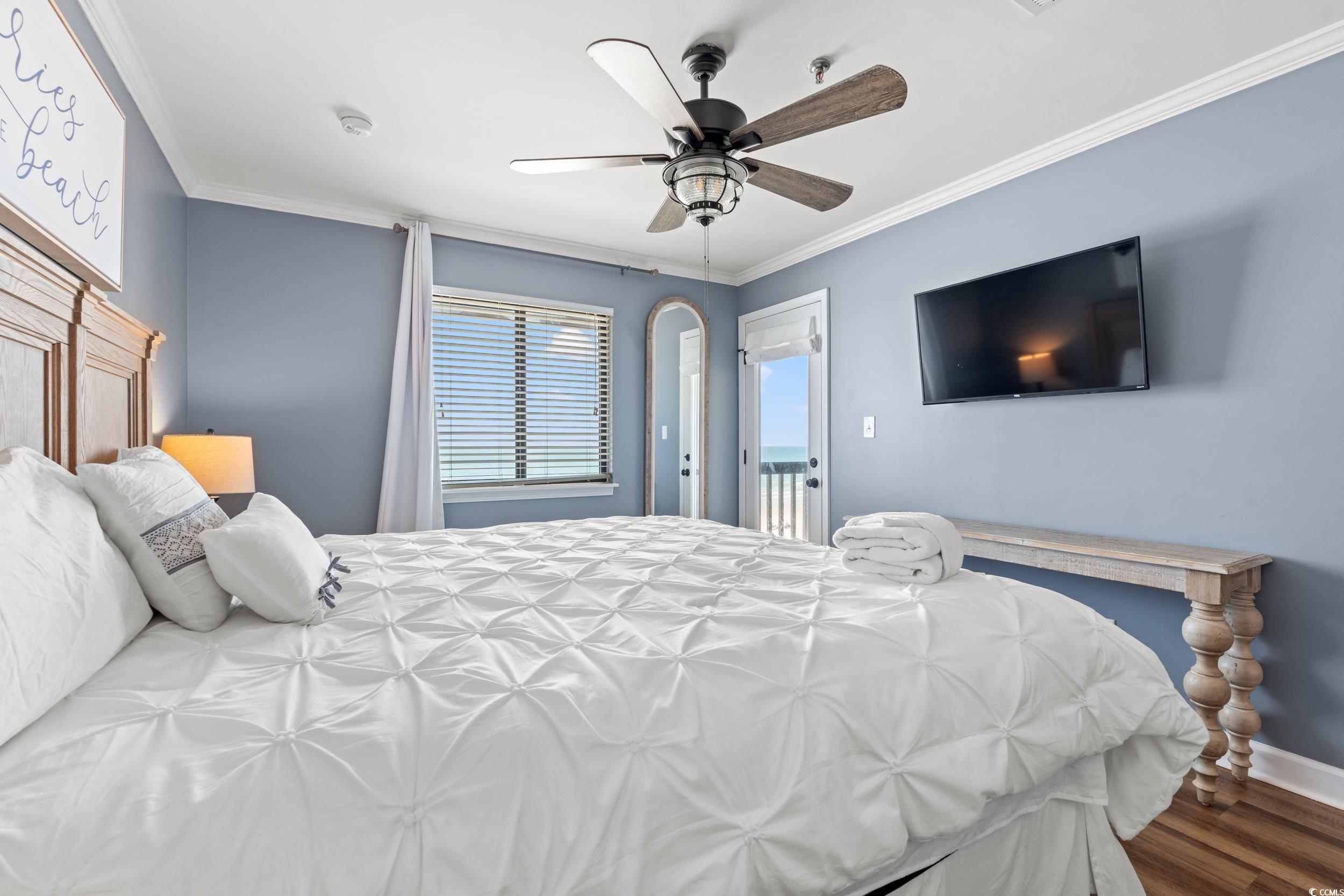 917 Ocean Boulevard South, Unit 304 Surfside Beach, SC 29575 - Photo 17 of 38 Bedroom with crown molding, dark wood-type flooring, a ceiling fan, and access to exterior