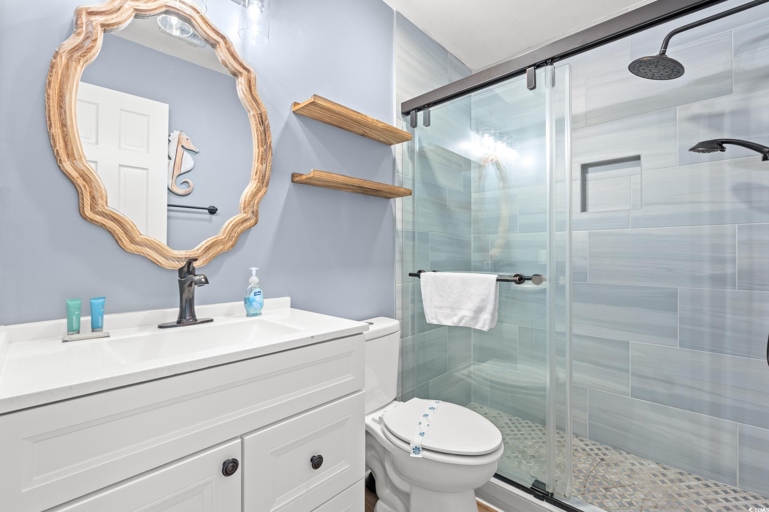 917 Ocean Boulevard South, Unit 304 Surfside Beach, SC 29575 - Photo 18 of 38 Full bath featuring a stall shower and vanity