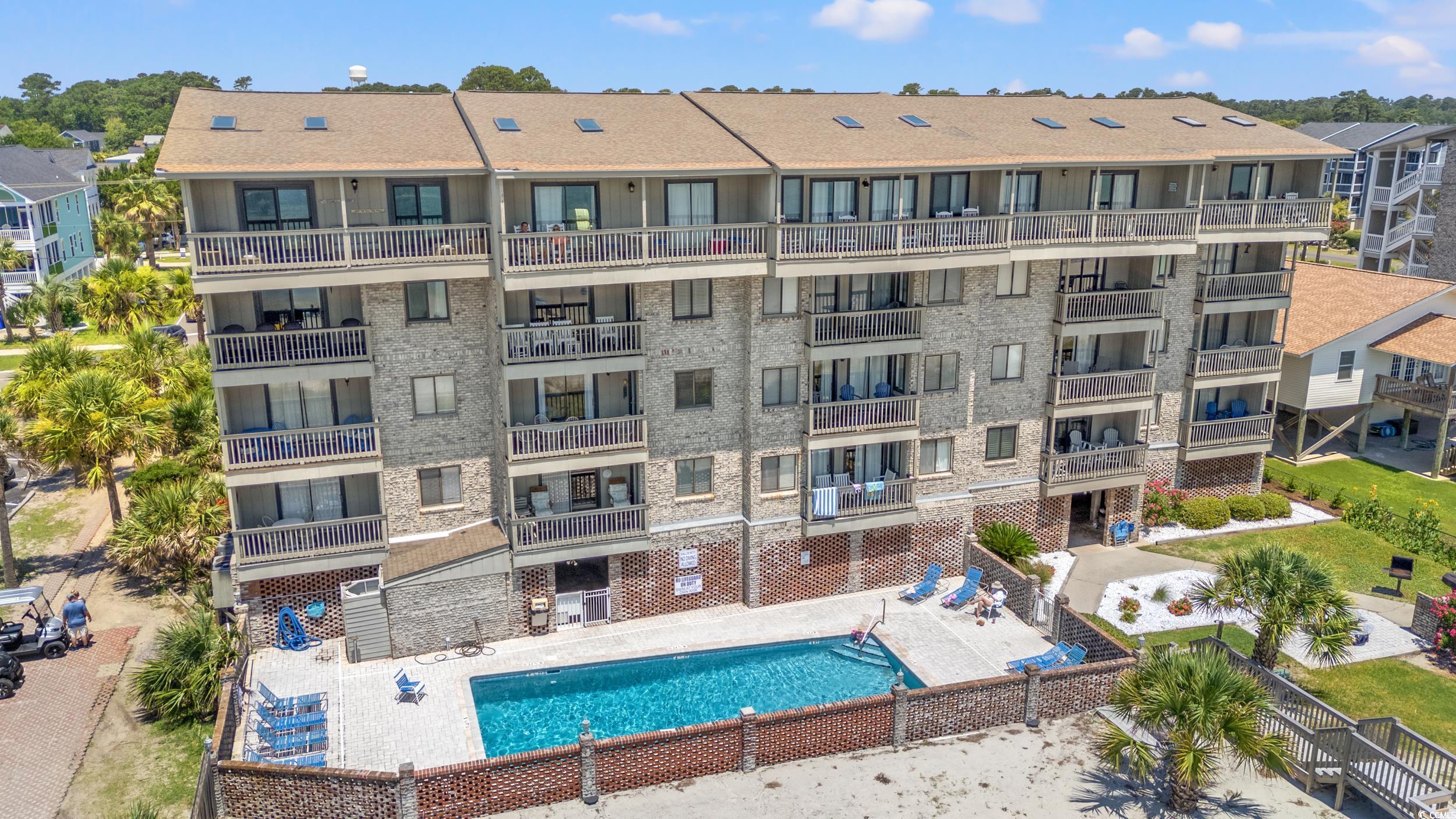 917 Ocean Boulevard South, Unit 304 Surfside Beach, SC 29575 - Photo 24 of 38 Community pool featuring a fenced backyard