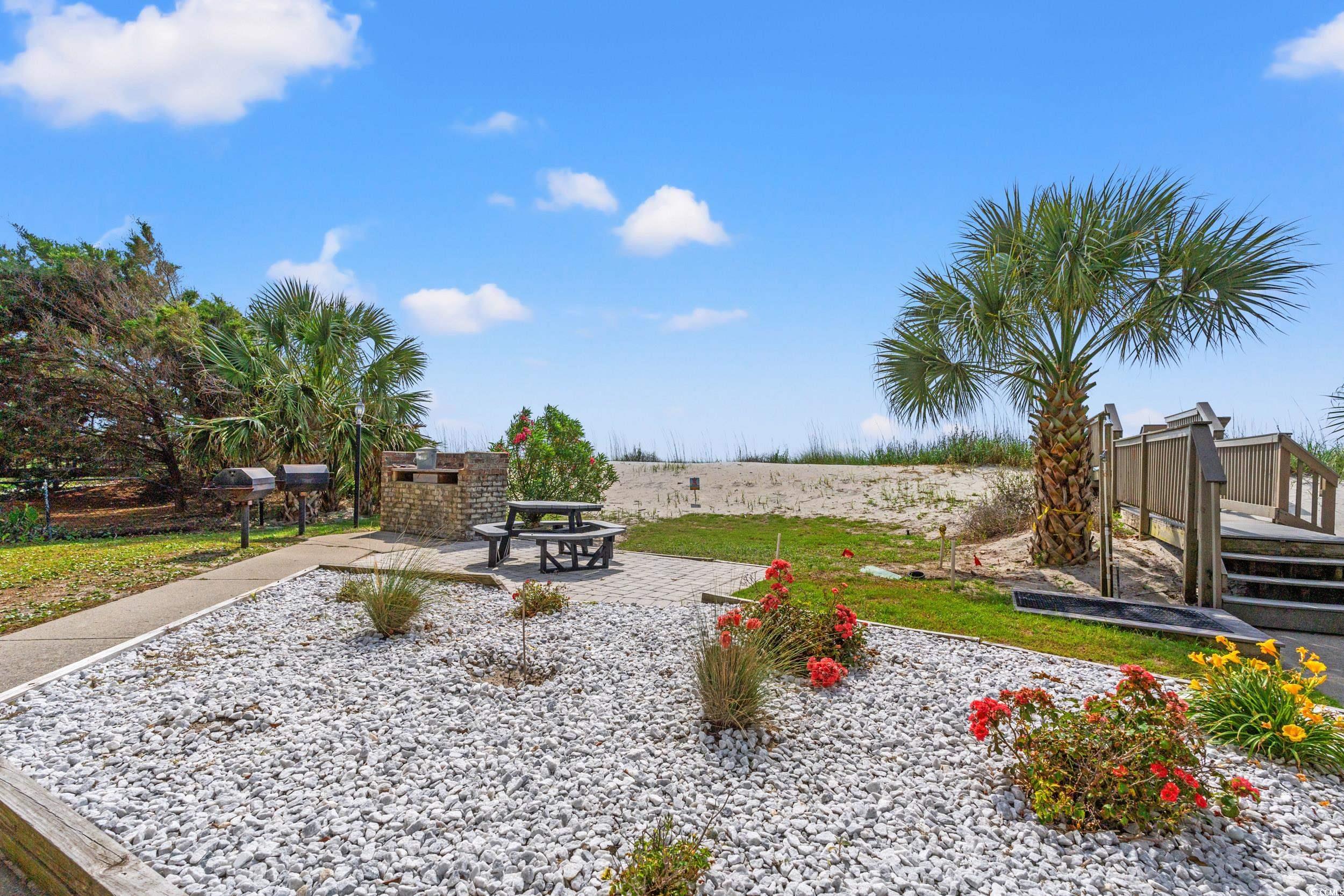 917 Ocean Boulevard South, Unit 304 Surfside Beach, SC 29575 - Photo 25 of 38 View of yard with a patio