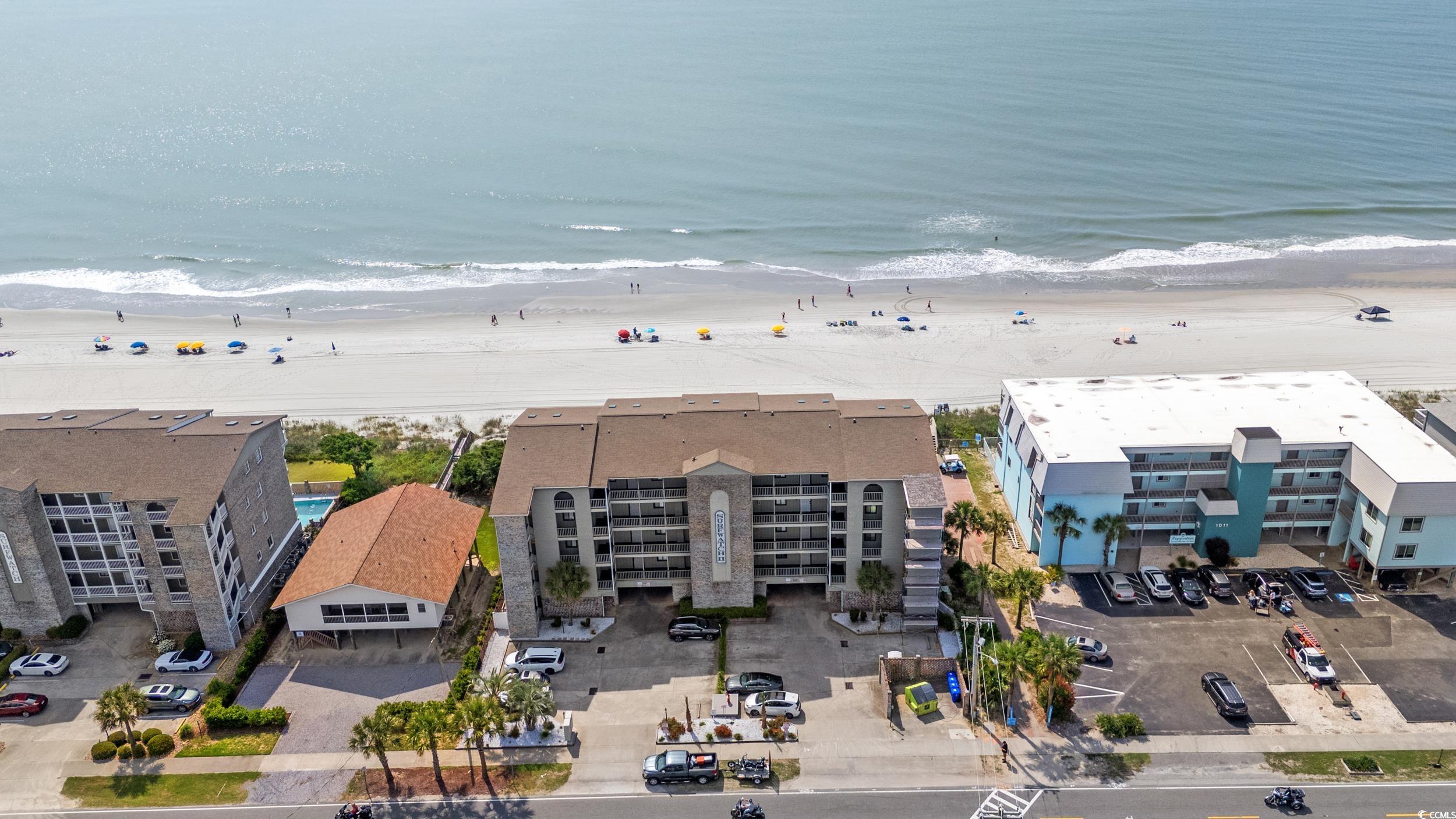 917 Ocean Boulevard South, Unit 304 Surfside Beach, SC 29575 - Photo 28 of 38 Aerial view of waterfront with a beach and apartment complex / building