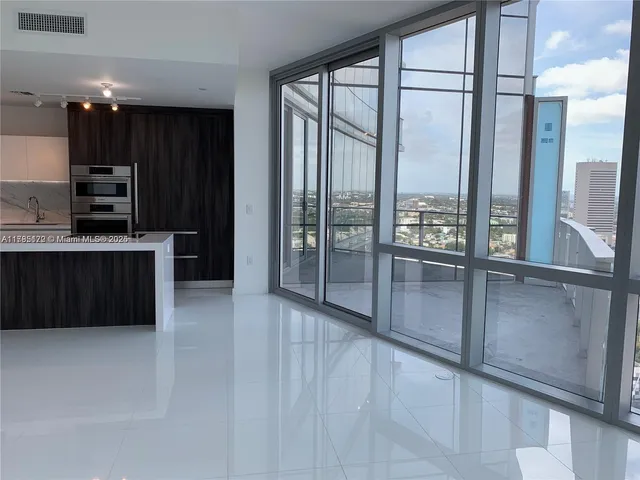 a view of kitchen with refrigerator and cabinets