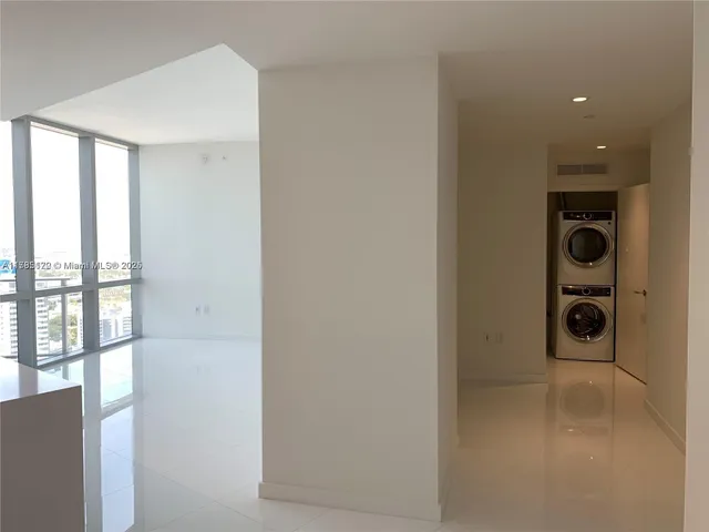 a view of a hallway with a washer and dryer