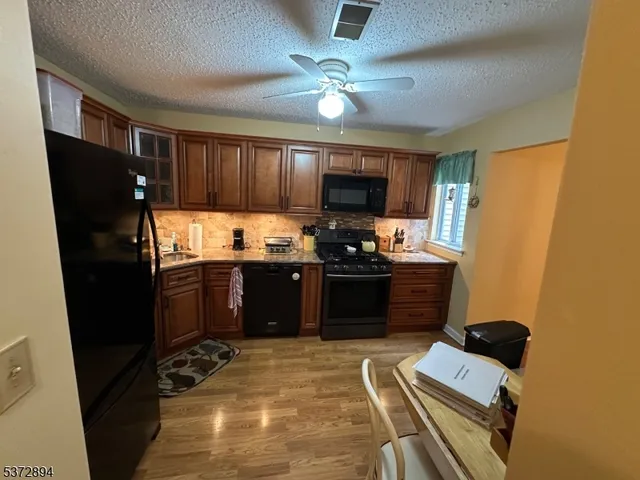 a kitchen with a refrigerator and a stove