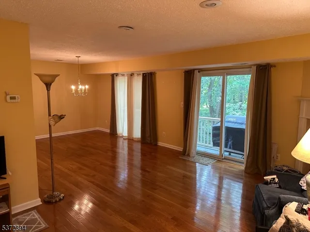 a view of livingroom with furniture wooden floor and windows