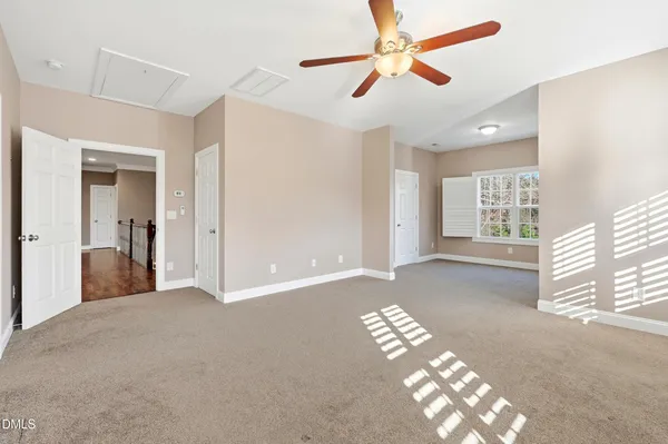 a view of a big room with chandelier fan and windows