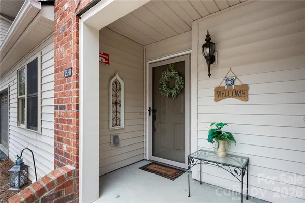 a front view of a house with a potted plant
