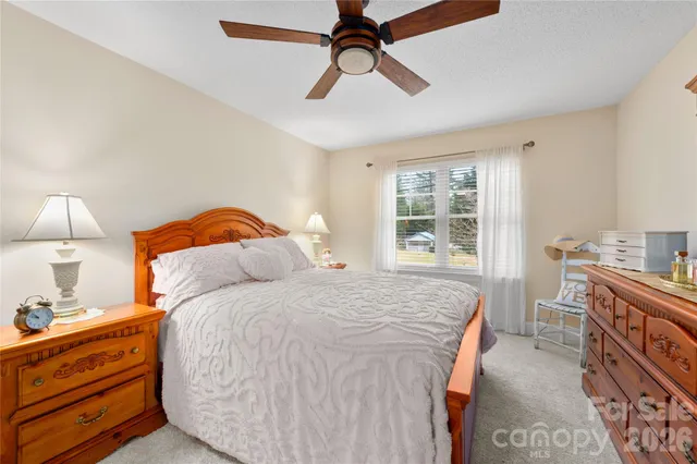 a bedroom with a bed and a dresser in it