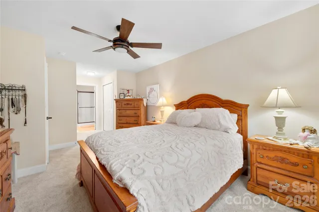 a bedroom with a bed and dresser with cabinets
