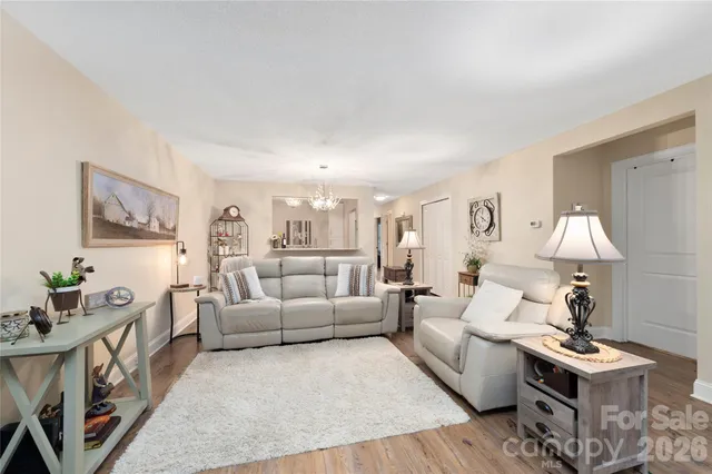 a living room with furniture a rug and a lamp