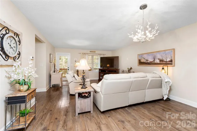 a living room with furniture and a chandelier