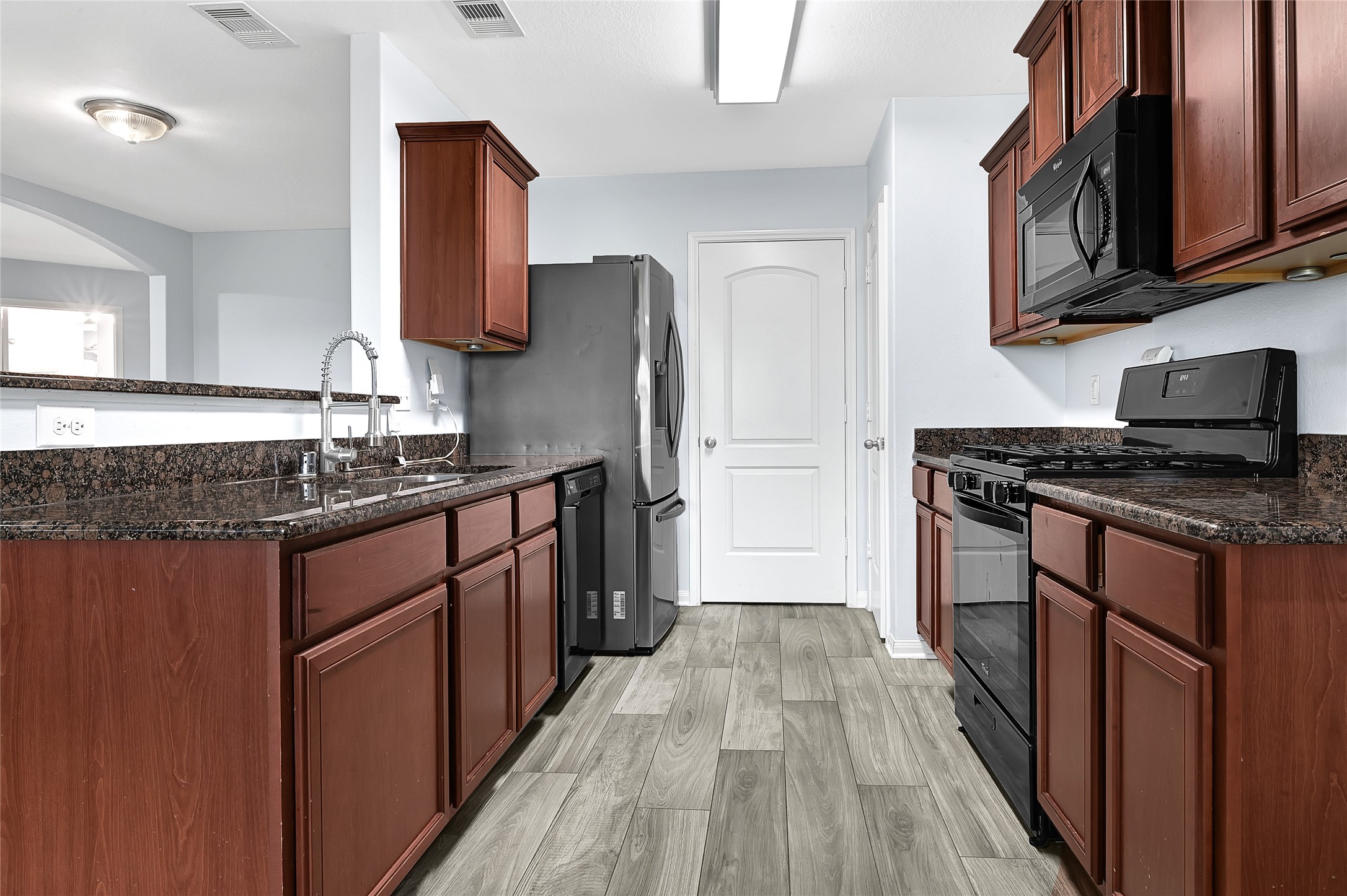 1802 Opal Peach Drive Rosharon, TX 77583 - Photo 13 of 35 a kitchen with stainless steel appliances granite countertop a stove a refrigerator and a sink
