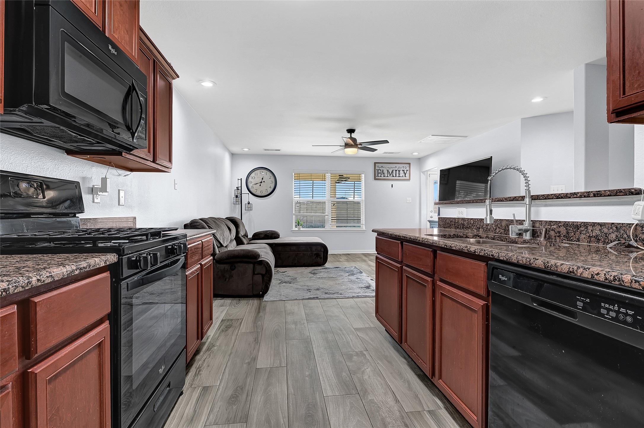 1802 Opal Peach Drive Rosharon, TX 77583 - Photo 14 of 35 a kitchen with granite countertop stainless steel appliances and wooden cabinets