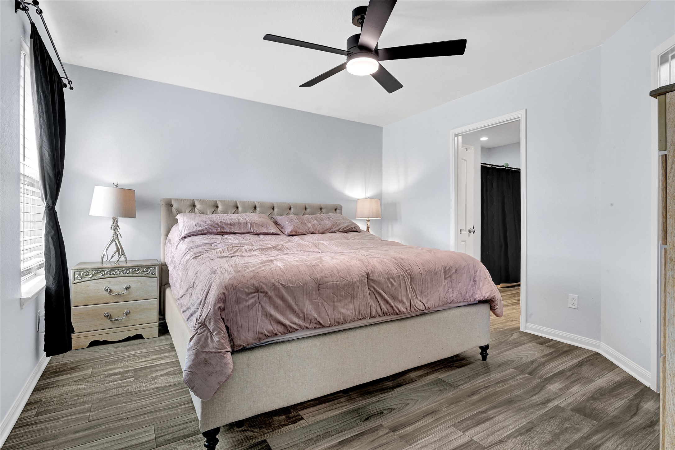 1802 Opal Peach Drive Rosharon, TX 77583 - Photo 16 of 35 a bedroom with a bed and a chandelier