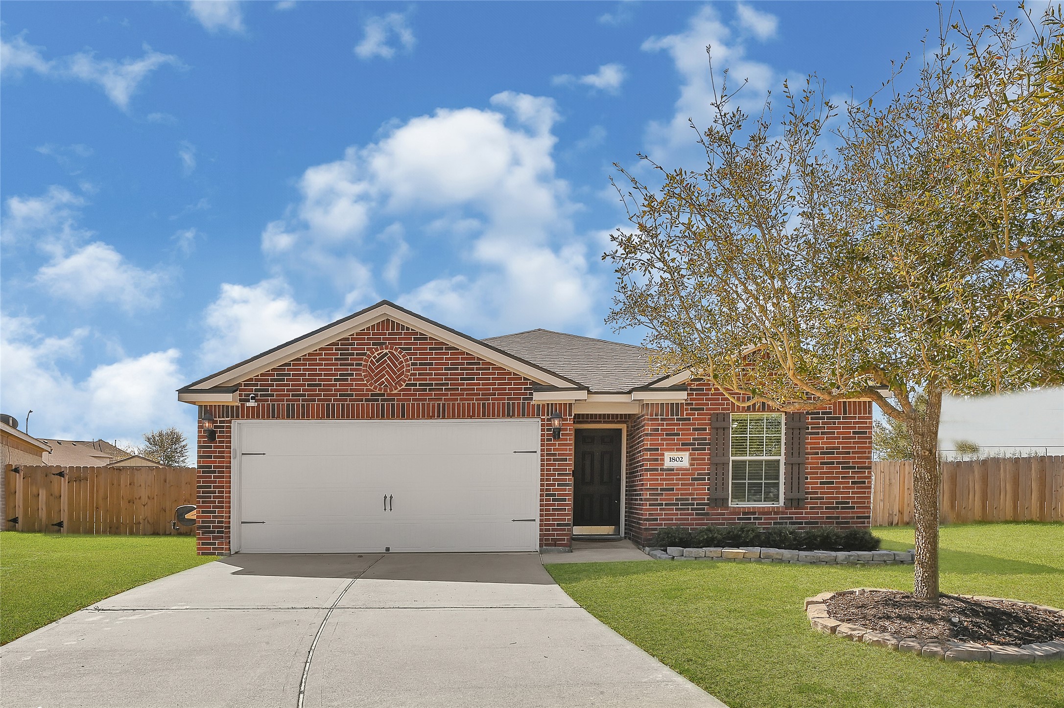1802 Opal Peach Drive Rosharon, TX 77583 - Photo 32 of 35 a front view of a house with a yard and garage