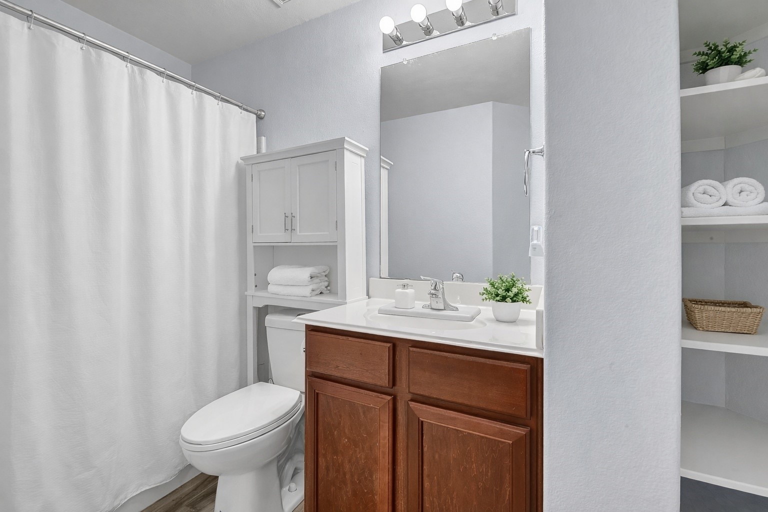 1802 Opal Peach Drive Rosharon, TX 77583 - Photo 35 of 35 a bathroom with a sink a toilet and shower curtain