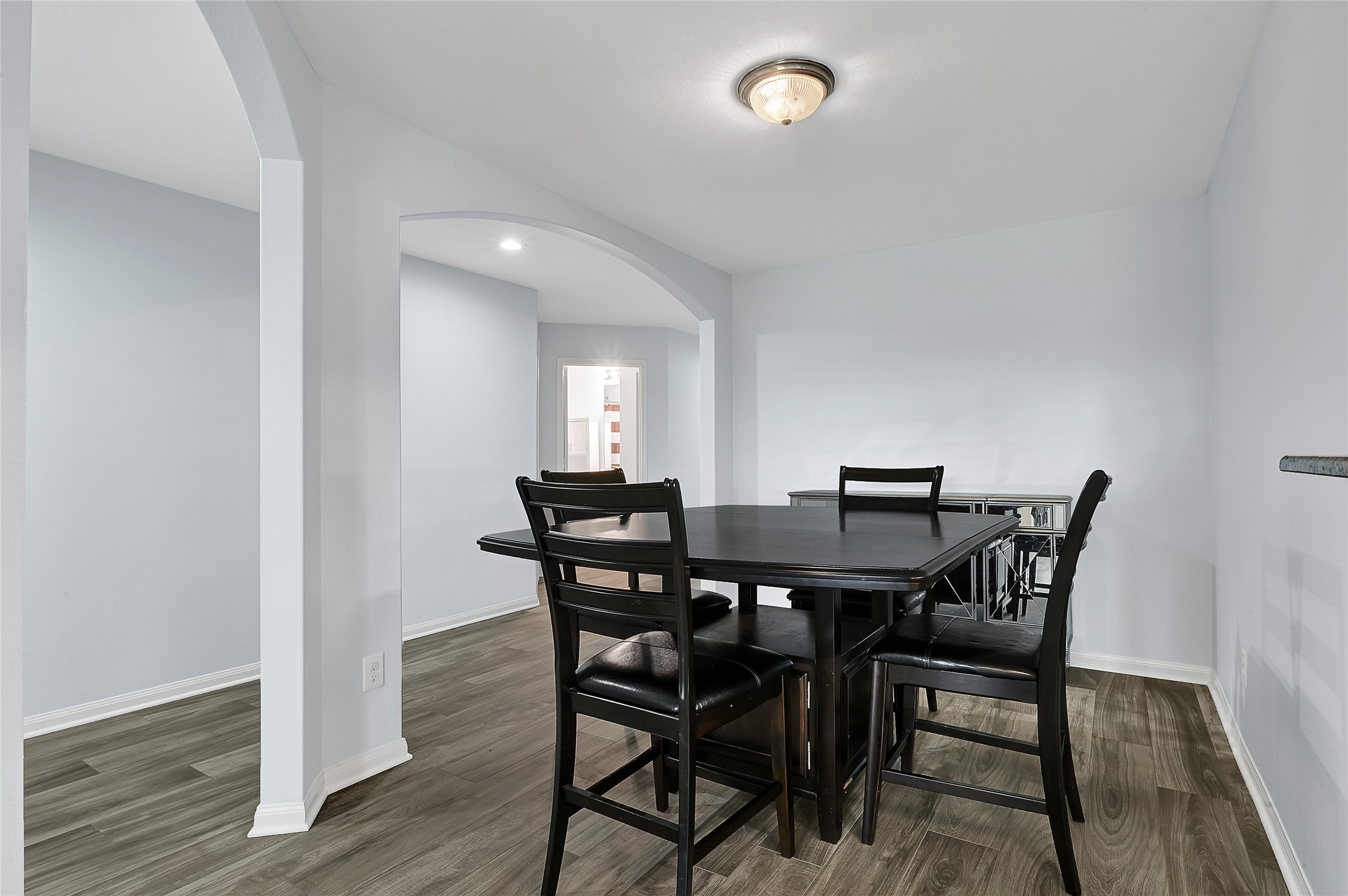 1802 Opal Peach Drive Rosharon, TX 77583 - Photo 8 of 35 a view of a dining room with furniture and wooden floor