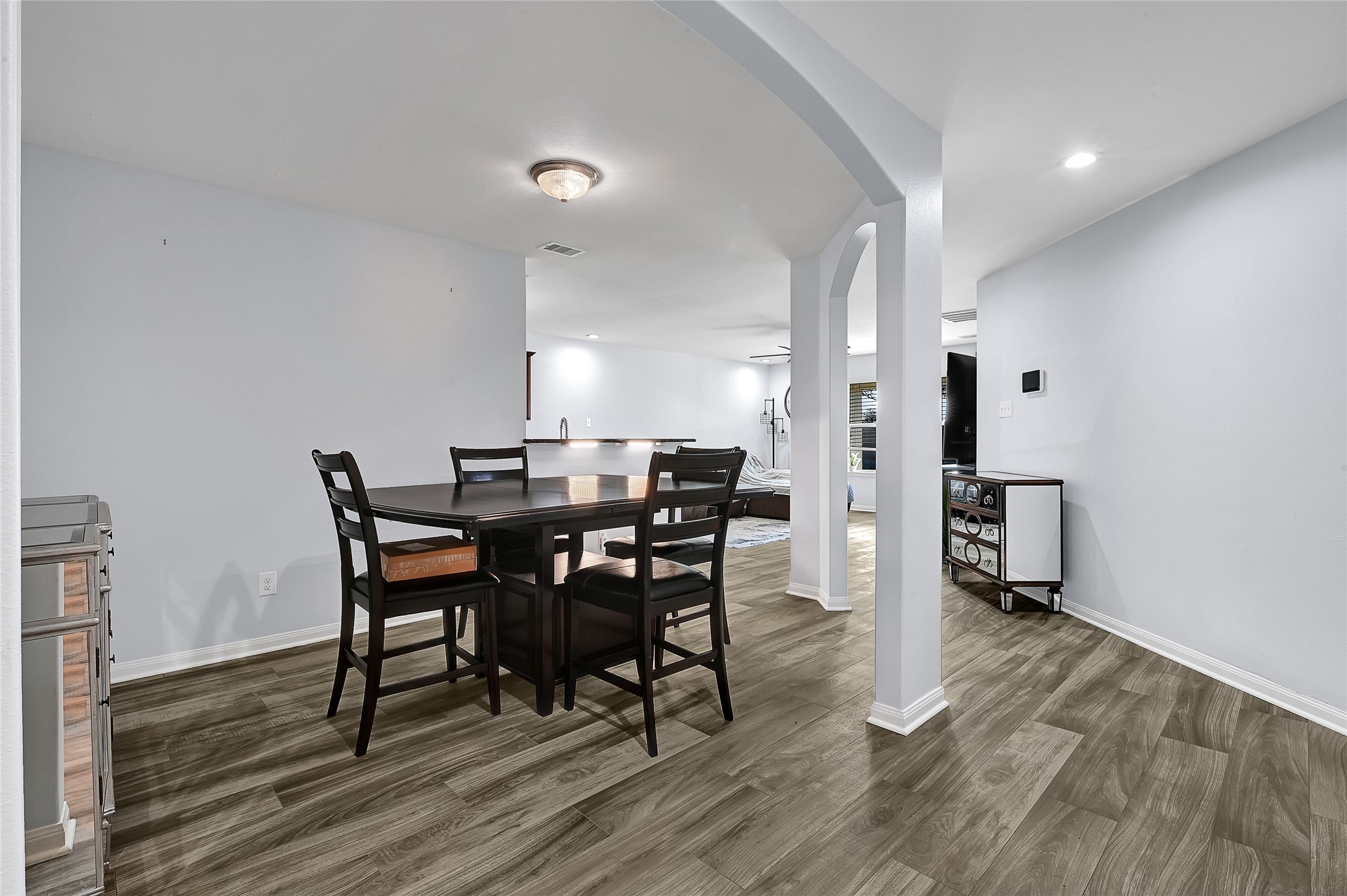 1802 Opal Peach Drive Rosharon, TX 77583 - Photo 9 of 35 a view of a dining room with furniture and wooden floor
