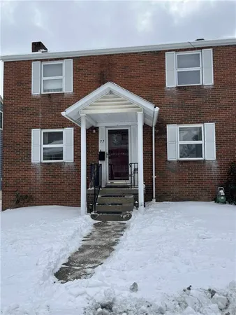 a view of a house with wooden walls and stairs