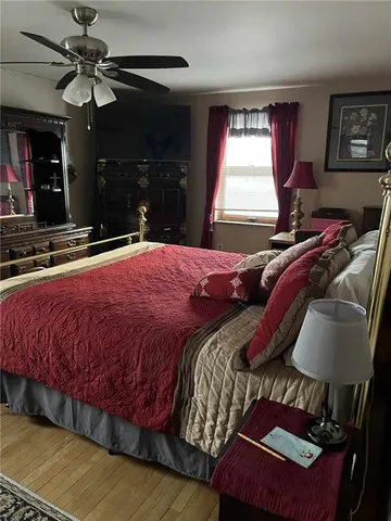 a bed sitting in a bedroom next to a window