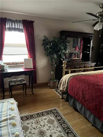 a bedroom with a bed and a potted plant
