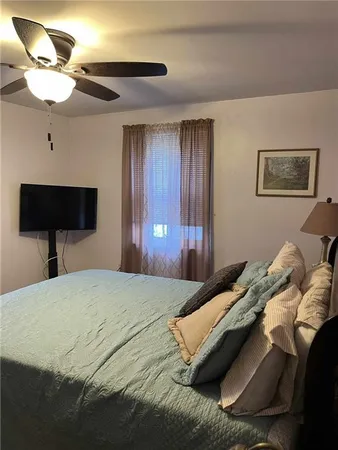 a bedroom with a bed and a lamp