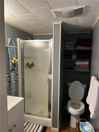 a bathroom with a toilet and a shower