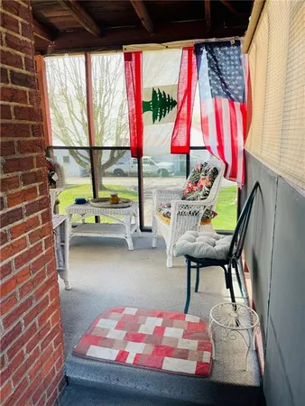 a bedroom with a bed a window and chair