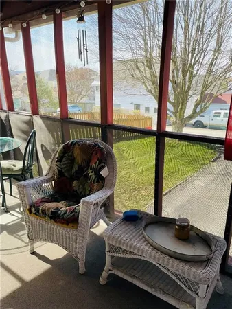 a living room with furniture and a floor to ceiling window