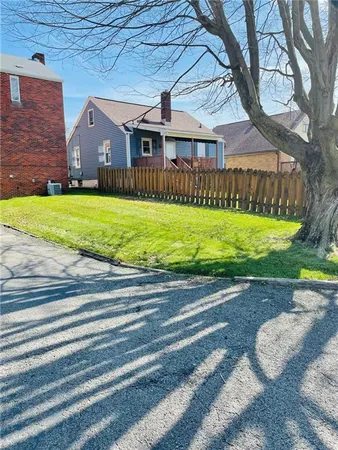 a front view of a house with a yard table and chairs