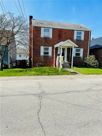 a front view of house with yard and green space