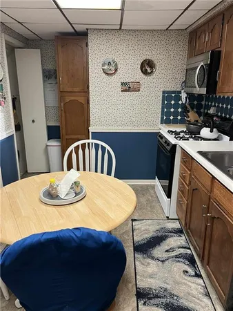 a kitchen with a sink a stove and refrigerator