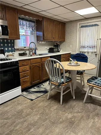 a kitchen with a sink a stove and a microwave