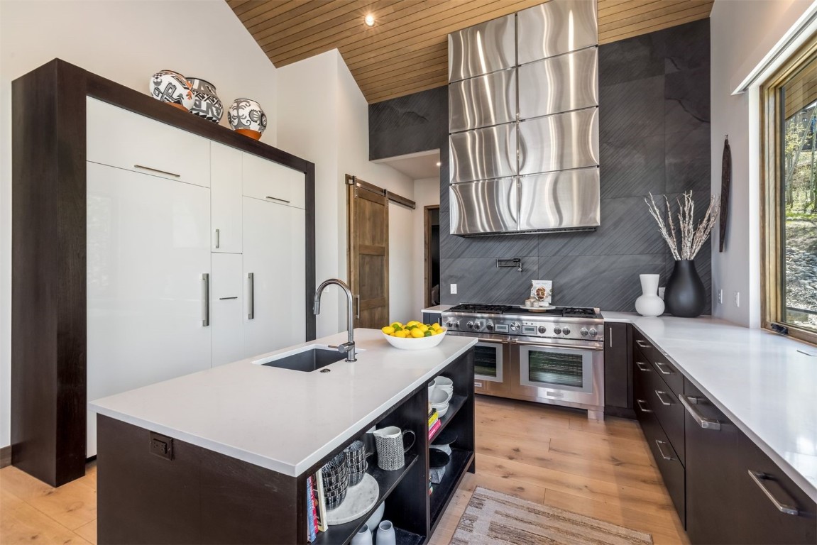 194 Angler Mountain Ranch Road Silverthorne, CO 80498 - Photo 14 of 50 a kitchen with stainless steel appliances granite countertop a stove a sink and a refrigerator