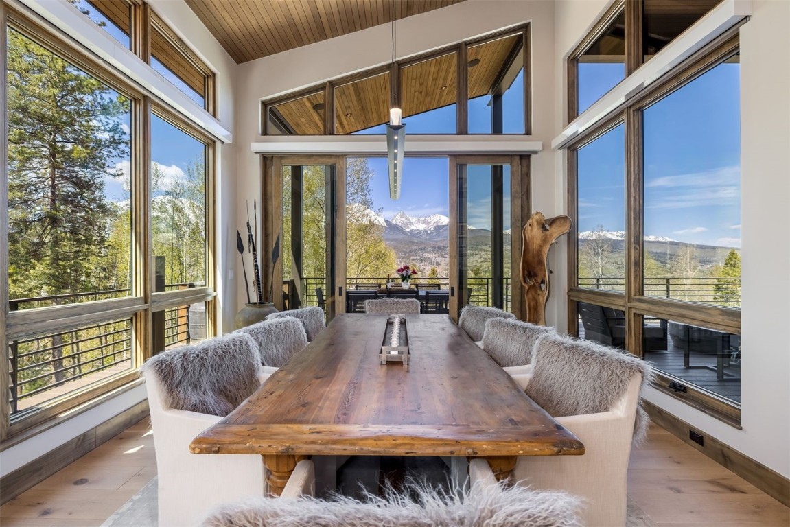 194 Angler Mountain Ranch Road Silverthorne, CO 80498 - Photo 15 of 50 a dining room with furniture large windows and a chandelier
