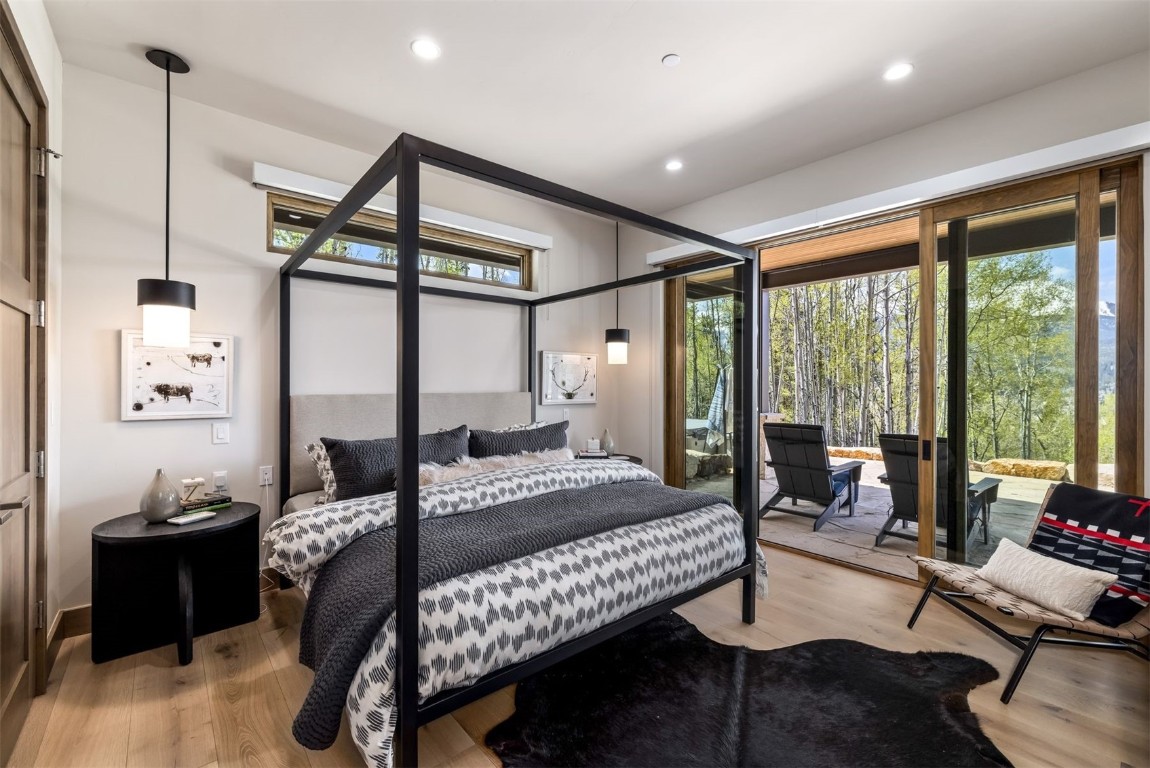 194 Angler Mountain Ranch Road Silverthorne, CO 80498 - Photo 40 of 50 a bedroom with a bed and wooden floor