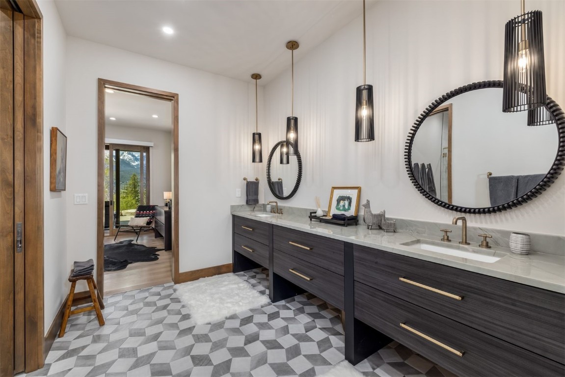 194 Angler Mountain Ranch Road Silverthorne, CO 80498 - Photo 41 of 50 a bathroom with a granite countertop sink mirror and vanity