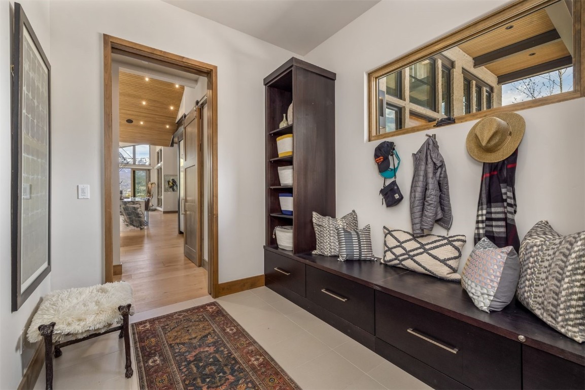 194 Angler Mountain Ranch Road Silverthorne, CO 80498 - Photo 46 of 50 a hallway with dining area and chandelier