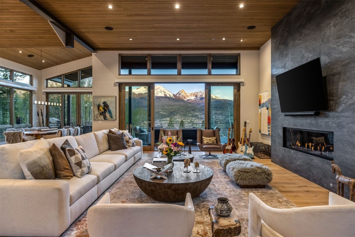 194 Angler Mountain Ranch Road Silverthorne, CO 80498 - Photo 6 of 50 a living room with fireplace furniture and a large window