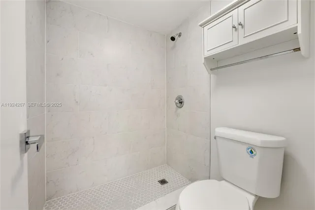 a bathroom with a toilet and shower