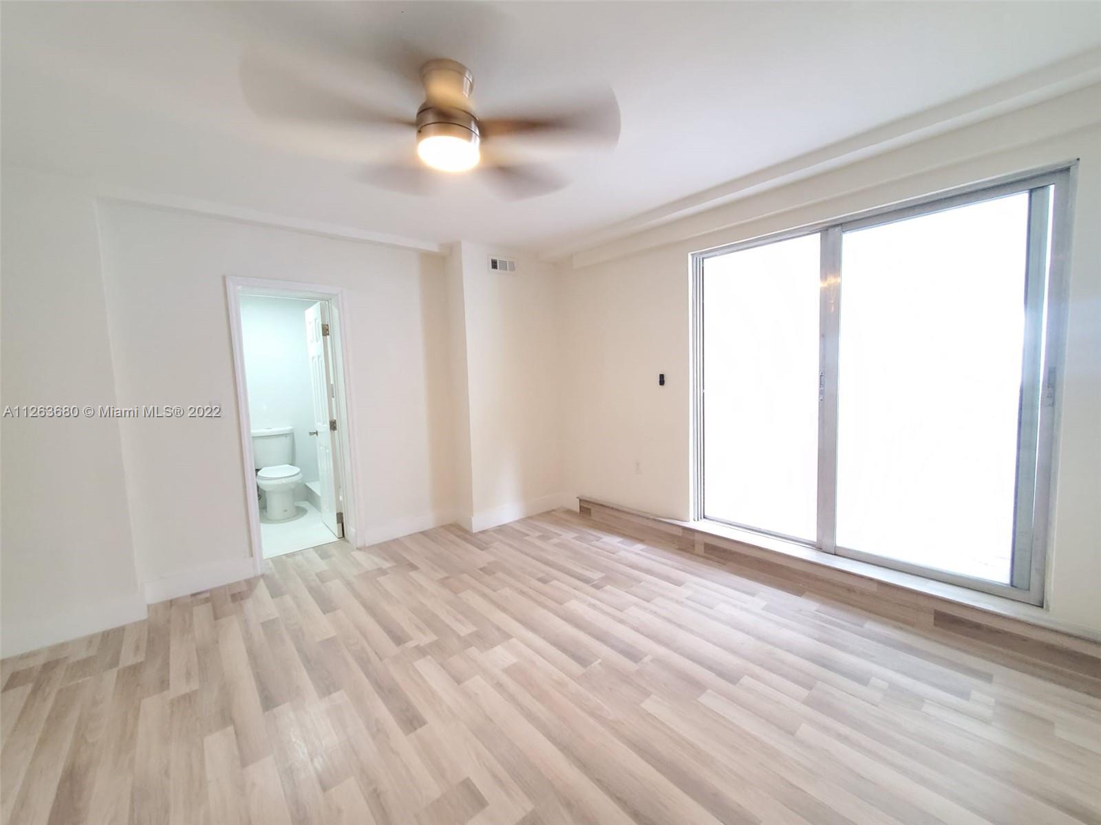 291 West 41st Street Hialeah, FL 33012 - Photo 13 of 40 a view of empty room with wooden floor and fan