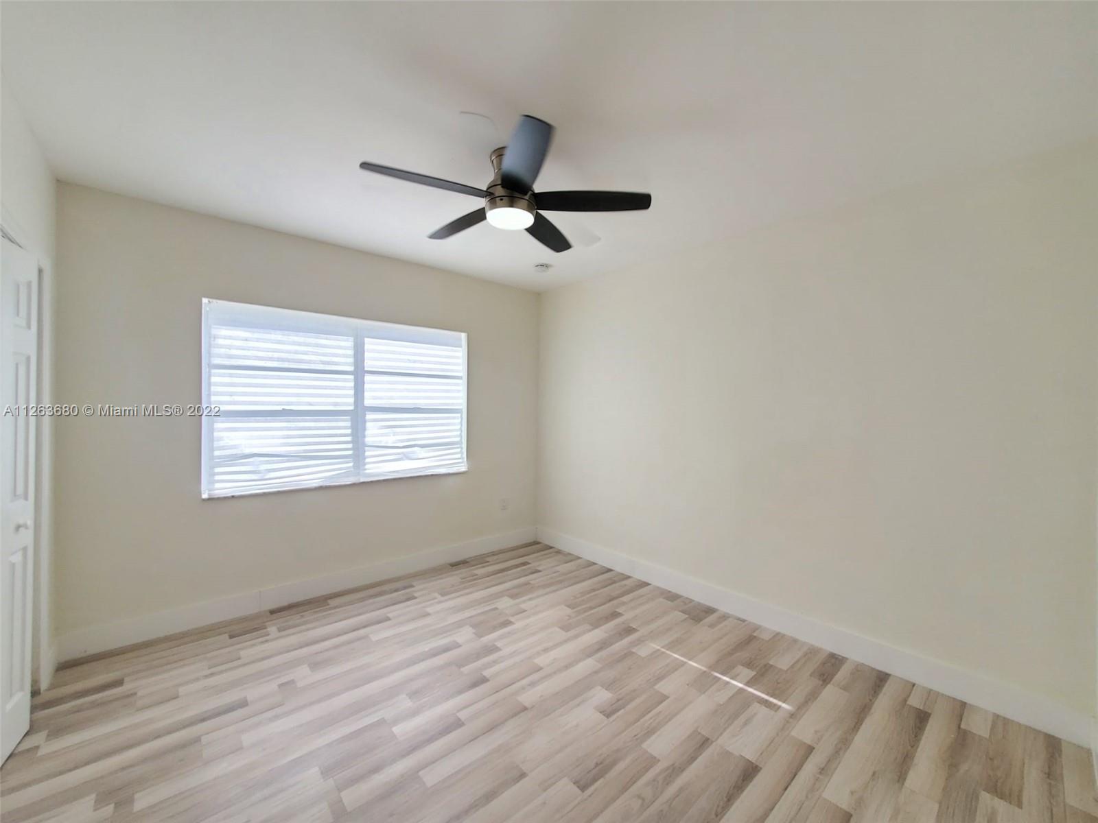 291 West 41st Street Hialeah, FL 33012 - Photo 16 of 40 a view of empty room with wooden floor and fan