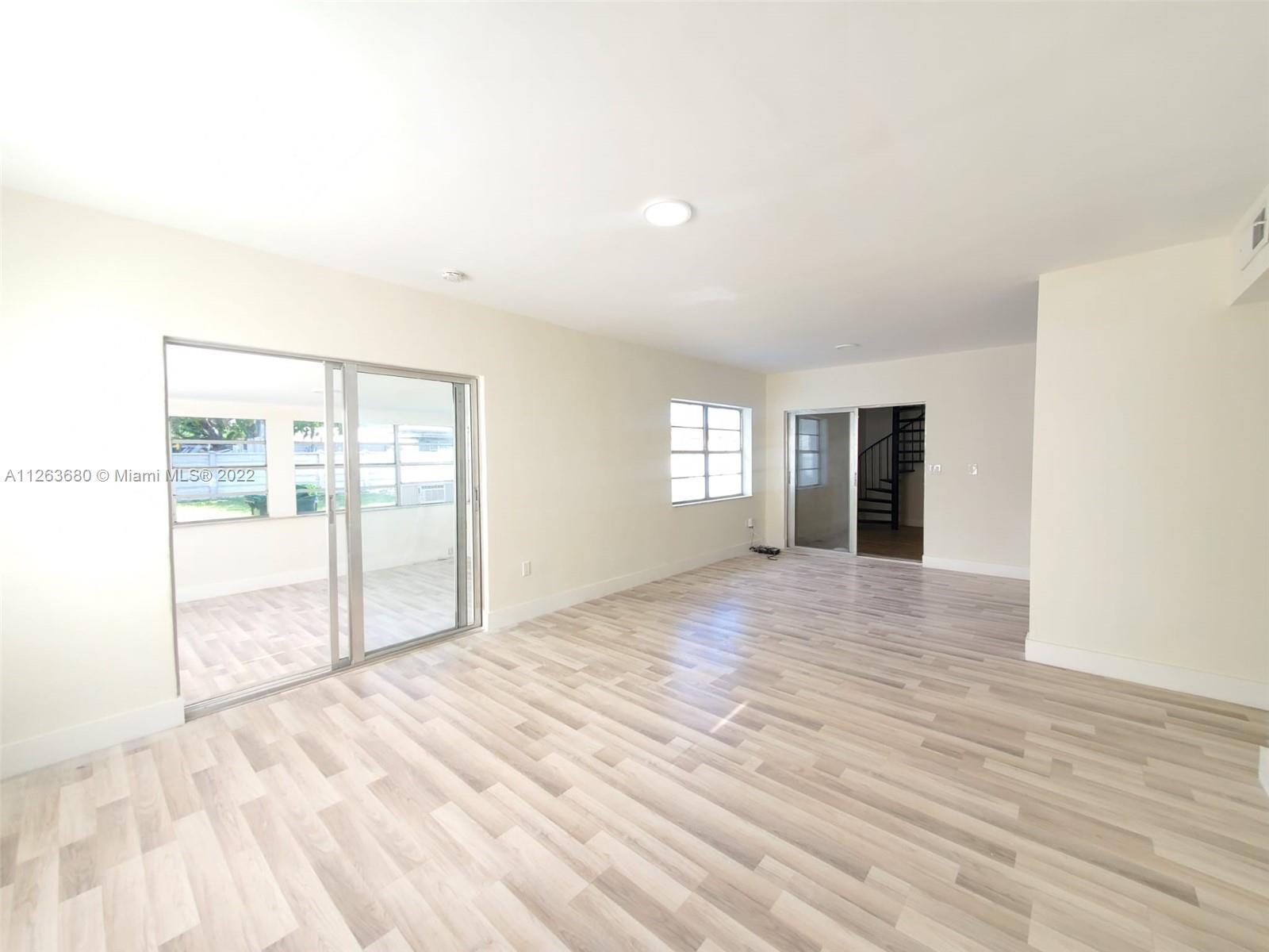 291 West 41st Street Hialeah, FL 33012 - Photo 3 of 40 a view of empty room with wooden floor and fan