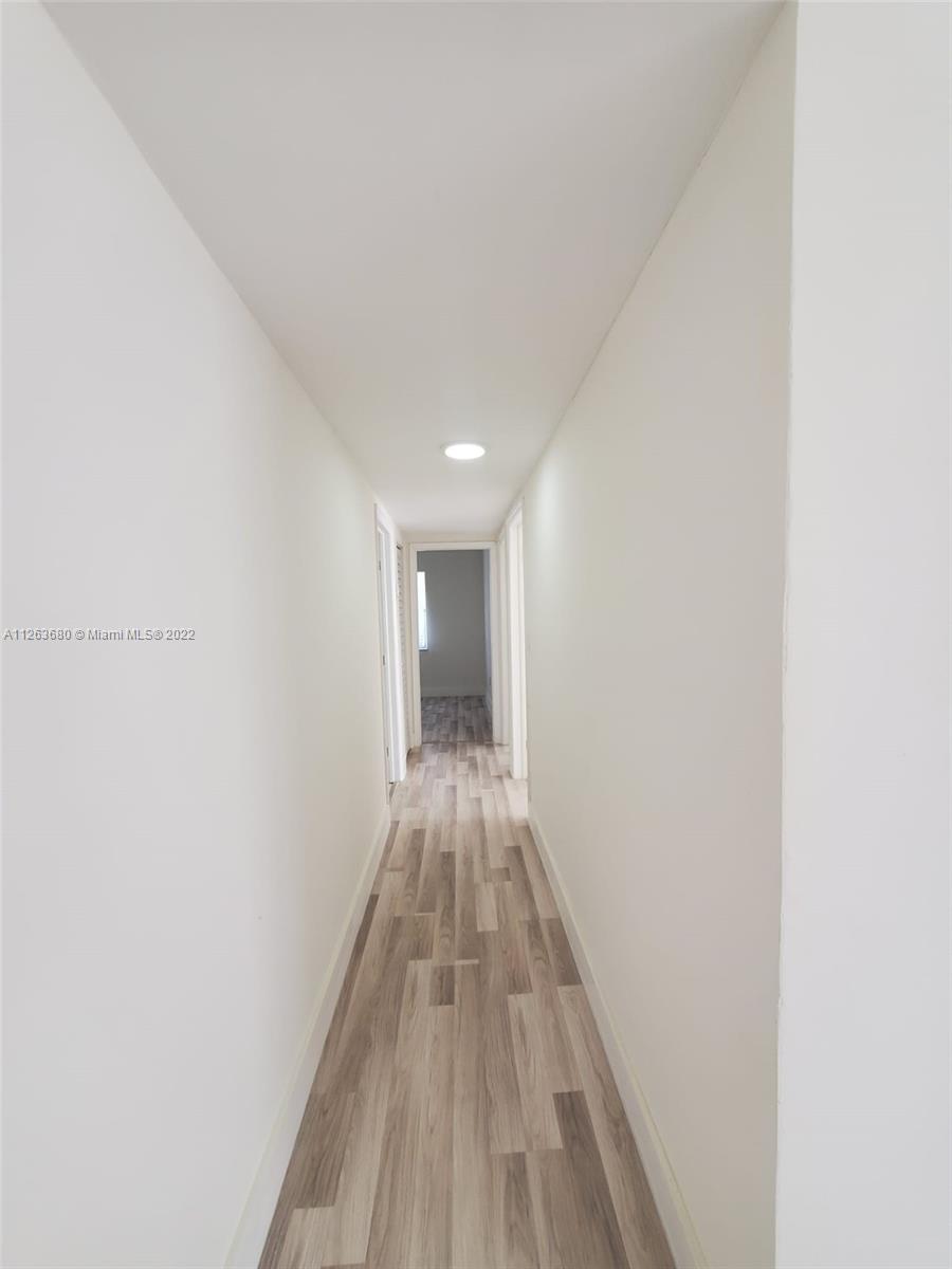 291 West 41st Street Hialeah, FL 33012 - Photo 31 of 40 a view of a hallway with wooden floor