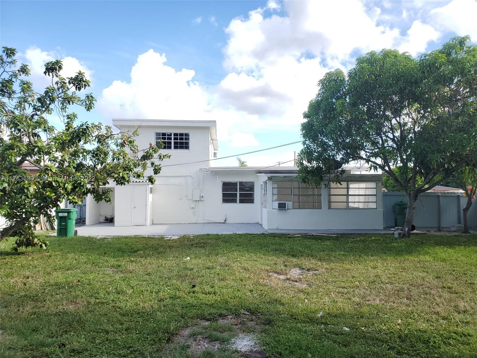 291 West 41st Street Hialeah, FL 33012 - Photo 35 of 40 a view of a yard in front of a house with plants and large tree