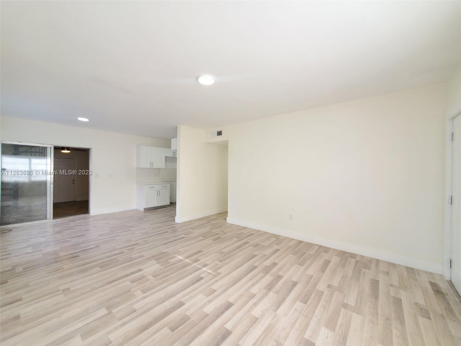 291 West 41st Street Hialeah, FL 33012 - Photo 5 of 40 a view of an empty room with wooden floor