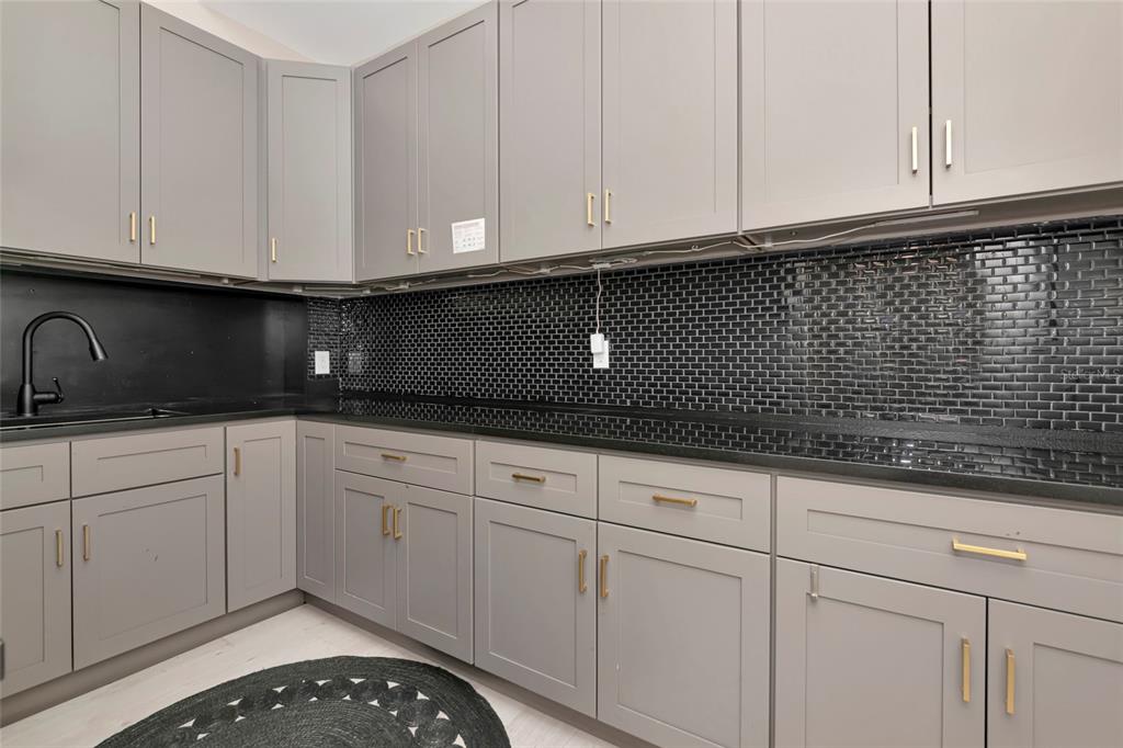 1345 2nd Street Sarasota, FL 34236 - Photo 30 of 98 a kitchen with white cabinets and a sink