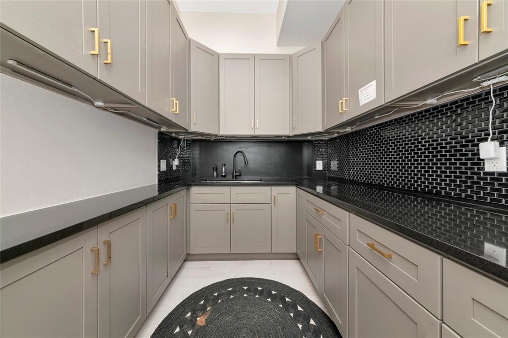 1345 2nd Street Sarasota, FL 34236 - Photo 31 of 98 a kitchen with granite countertop white cabinets and black appliances